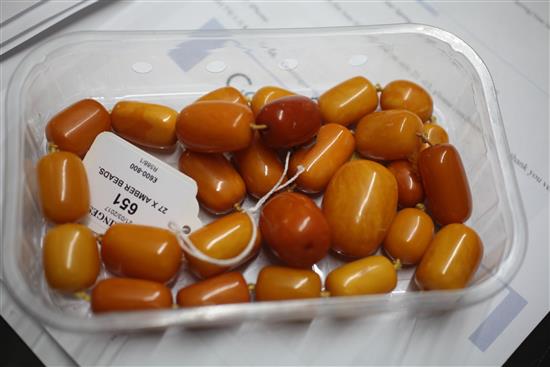 Twenty seven graduated amber beads,